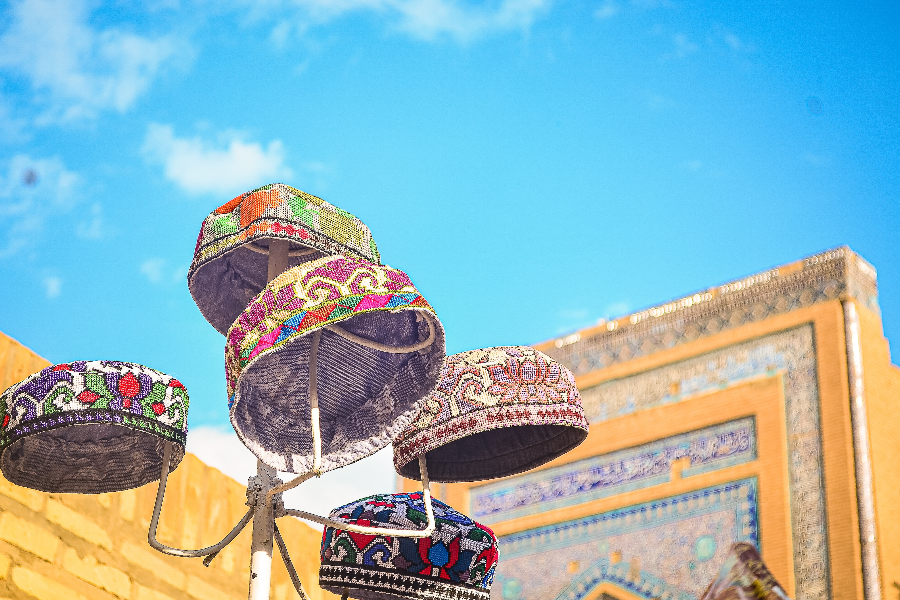 Cap seller in market area of Khiva - 2501157739