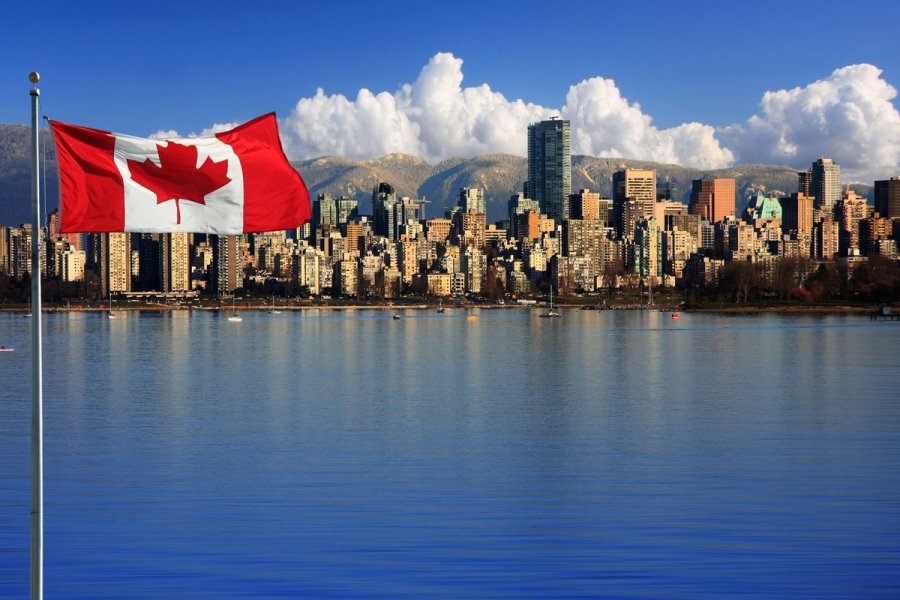 Le drapeau canadien devant la ville de Vancouver.
